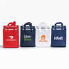 Four insulated reusable bags in red, navy, white, and black, featuring logos on each bag.