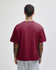 A maroon unisex boxy t-shirt viewed from the back, with a simple design and short sleeves.