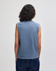A blue heavyweight cotton unisex muscle t-shirt with a boxy fit, featuring a sleeveless design and a branding logo.