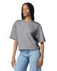A grey women's mid-length boxy top with short sleeves, featuring a relaxed fit and a brand logo.