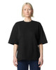 A black oversized boxy top with short sleeves. The top has a simple design and features a branding logo.