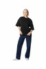 A black oversized boxy top worn with blue denim jeans, featuring a casual, relaxed fit and a logo.