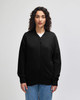 A black unisex bomber jacket made of French terry fabric, featuring a zip front and ribbed cuffs.