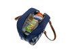 A blue and white checkered insulated lunch bag with a brown strap, filled with drinks and snacks.