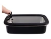 A rectangular stainless steel container with a black lid, featuring a handle for easy lifting.