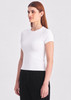 A fitted white women's baby tee displayed on a model, paired with black bottoms, featuring a subtle logo.