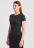 A fitted women's baby tee in black, featuring short sleeves and a round neckline. The model is standing to the side.