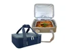 A navy blue and beige insulated food bag with a large, cooked dish inside, featuring a handle and zippers.
