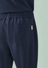 Navy unisex straight leg scrub pant with an elastic waistband and a back pocket. Includes a logo.
