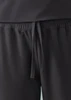 A pair of black jogger scrub pants featuring an elastic waistband and drawstring tie. Logo present.