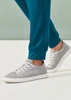 A pair of teal jogger scrub pants paired with grey athletic shoes, featuring a relaxed fit and tapered ankles.