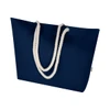 A navy blue beach tote bag with white rope handles and a branding logo.