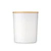 A white candle holder with a bamboo lid. The design is simple and elegant, suitable for home decor.