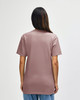A midweight t-shirt in a muted pink shade, featuring a plain back and short sleeves. It has a branding logo.