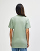 A man wearing a green Gildan Softstyle Adult Midweight T-Shirt, viewed from the back. The shirt has a logo.