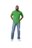 A green Gildan Softstyle adult midweight T-shirt displayed on a male model, paired with blue jeans and white shoes.