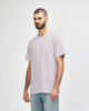 A light grey Gildan Softstyle adult T-shirt displayed on a model, featuring a relaxed fit and no visible logo.