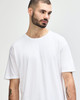 A white Gildan Softstyle adult T-shirt displayed on a model with a neutral background, featuring a logo.