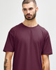 A close-up of a male model wearing a maroon Gildan Softstyle adult T-shirt with a round neckline.