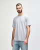 A plain grey adult t-shirt displayed on a male model, featuring a relaxed fit and short sleeves.