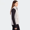 A grey women's hybrid vest is displayed on a model, featuring a zip front and side pockets.