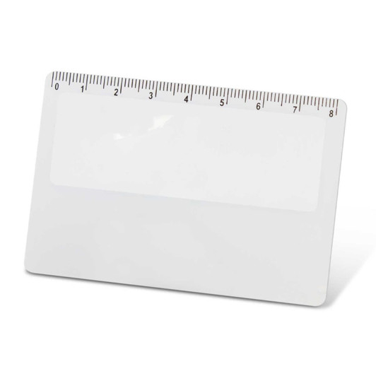 A card magnifier with a ruler along the top edge and a clear, smooth surface.
