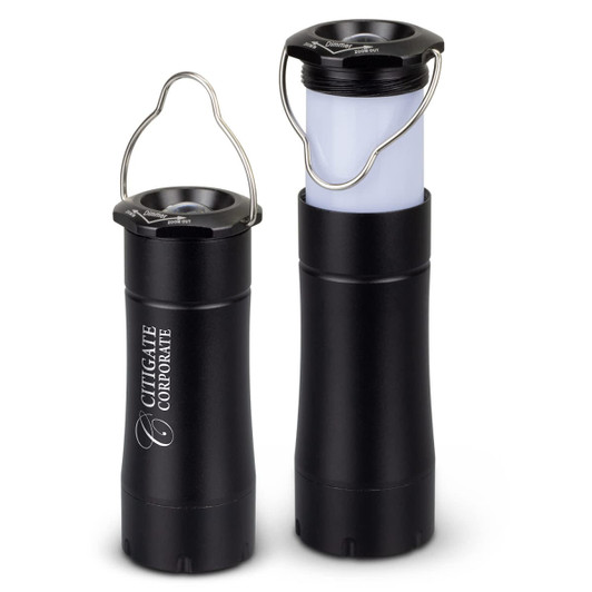 A black flashlight lantern with a handle, featuring a translucent section for light emission. Includes branding.