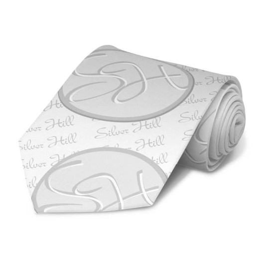 A grey tie featuring a repeating pattern of stylised initials and the name "Silver Hill". It has a branded logo.