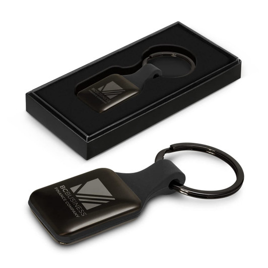 A square black key ring with a smooth finish, presented in a sleek black box, featuring a logo.