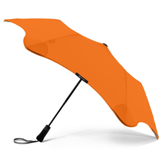 An orange BLUNT Metro Umbrella with a sleek design and a branded handle.