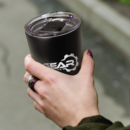 A drink bottle in matte black with a clear lid, held in a hand, featuring a logo on the side.