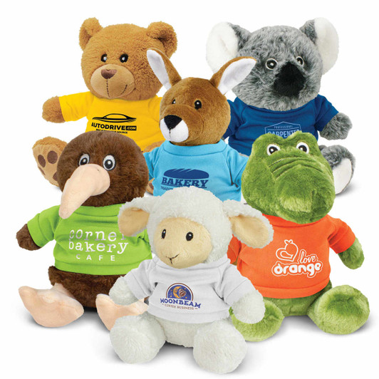 A variety of plush toys including a bear, kangaroo, kiwi, sheep, and crocodile, all wearing colourful shirts.