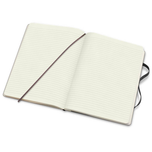 An extra-large soft cover Moleskine notebook featuring lined pages and a dark elastic closure.