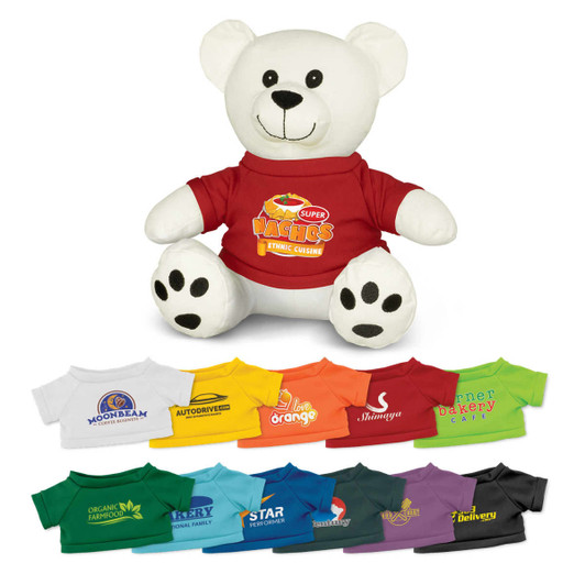 A plush white bear toy wearing a red shirt, surrounded by various coloured t-shirts in different styles.