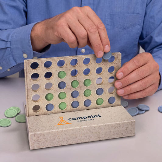 A person places a blue disc in a Four in a Row game, featuring green and blue discs in a textured box.