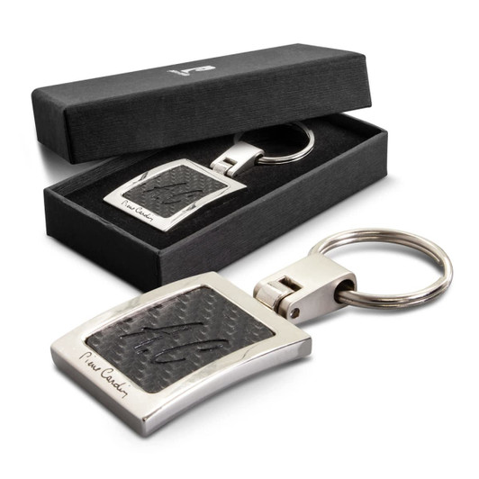 A silver key ring featuring a textured black design, presented in a black gift box.