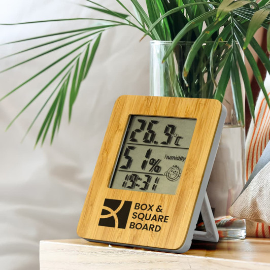 A bamboo weather station with temperature and humidity displays, featuring a wooden frame and a logo.