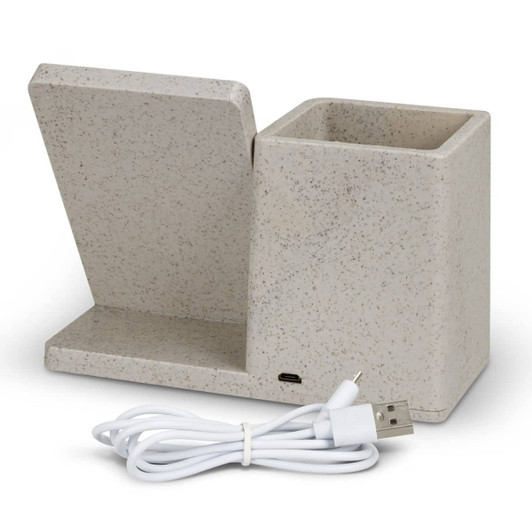 A beige wireless charger desk caddy with a slot for devices and a compartment for storage, accompanied by a USB charging cable.