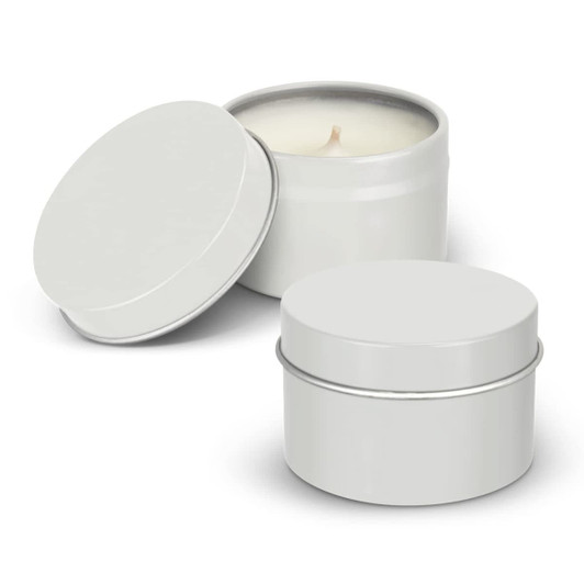 A set of two silver travel candles in metal tins, one with an open lid revealing a cream-coloured wax.