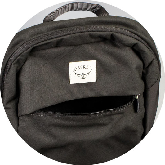 A black backpack featuring a front zip pocket and a brand logo. The fabric appears durable and sturdy.