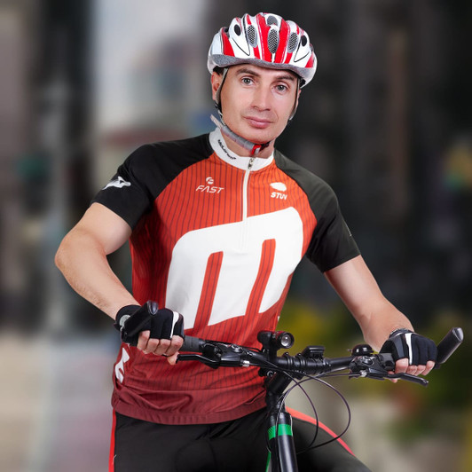 A custom men's cycling top in red and black worn by a cyclist, with a helmet and gloves. The top features a logo.