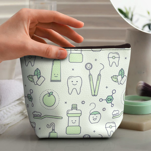 A small cosmetic bag in mint green with dental-themed illustrations and a zipper closure, featuring a branded logo.