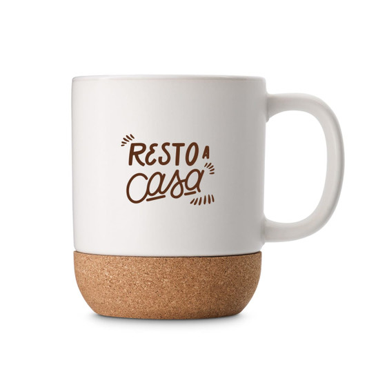 A white ceramic mug with a cork base, featuring text and a logo design.