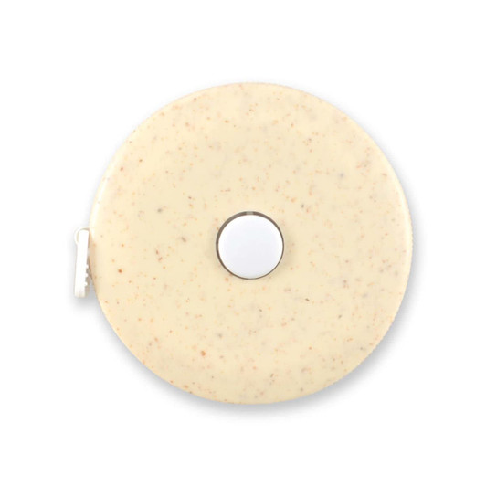 A tape measure featuring a circular body made of wheat fiber, showcasing a smooth, light-colored surface with speckles.