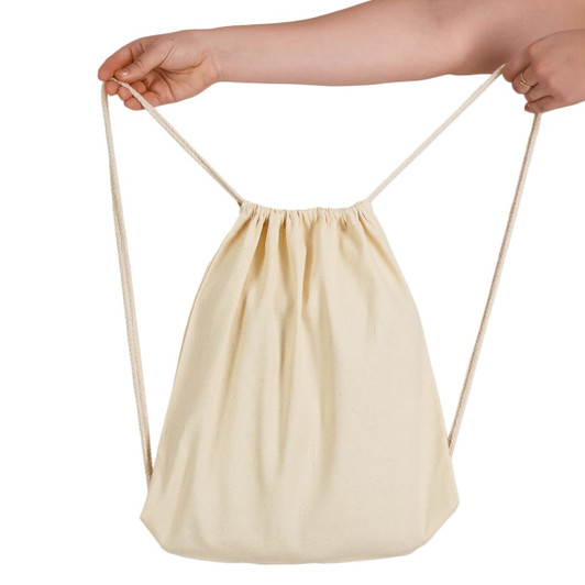 A cream drawstring backpack with a cinched opening, held by a hand. It features a simple design and a logo.