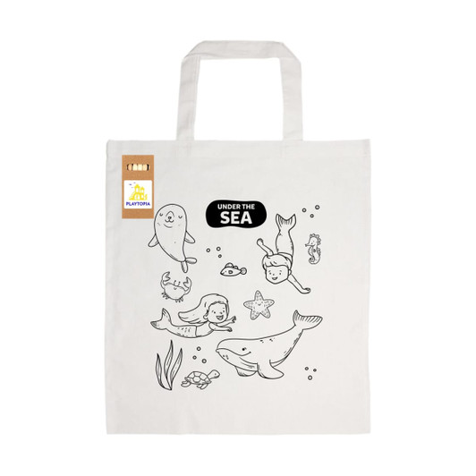 A cream cotton bag featuring whimsical sea-themed illustrations, including sea creatures and children, with a logo.
