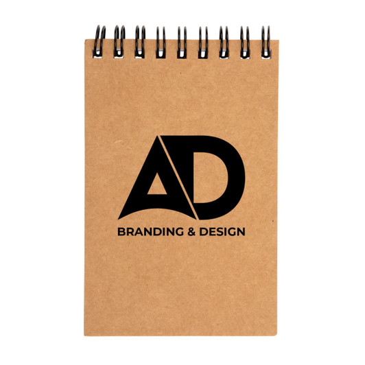 A spiral-bound pocket notebook with a kraft cover featuring the logo "AD" along with the text "BRANDING & DESIGN".