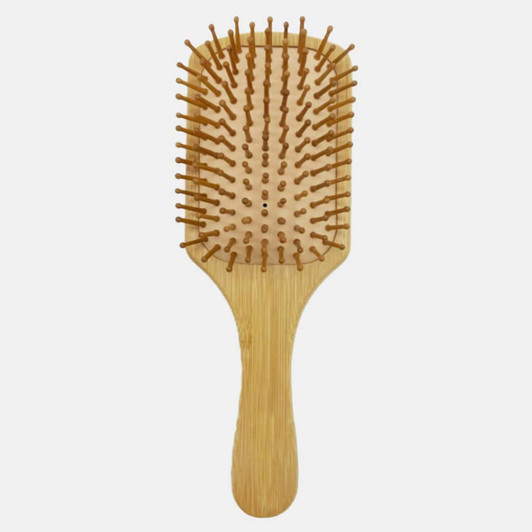 A bamboo hairbrush with a wooden handle and bristles, featuring a rectangular paddle design.
