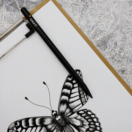 A black pencil rests on a sheet of paper featuring a detailed butterfly illustration.