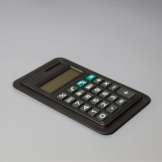 A black calculator with an LCD display and a full set of numeric buttons, featuring a logo.